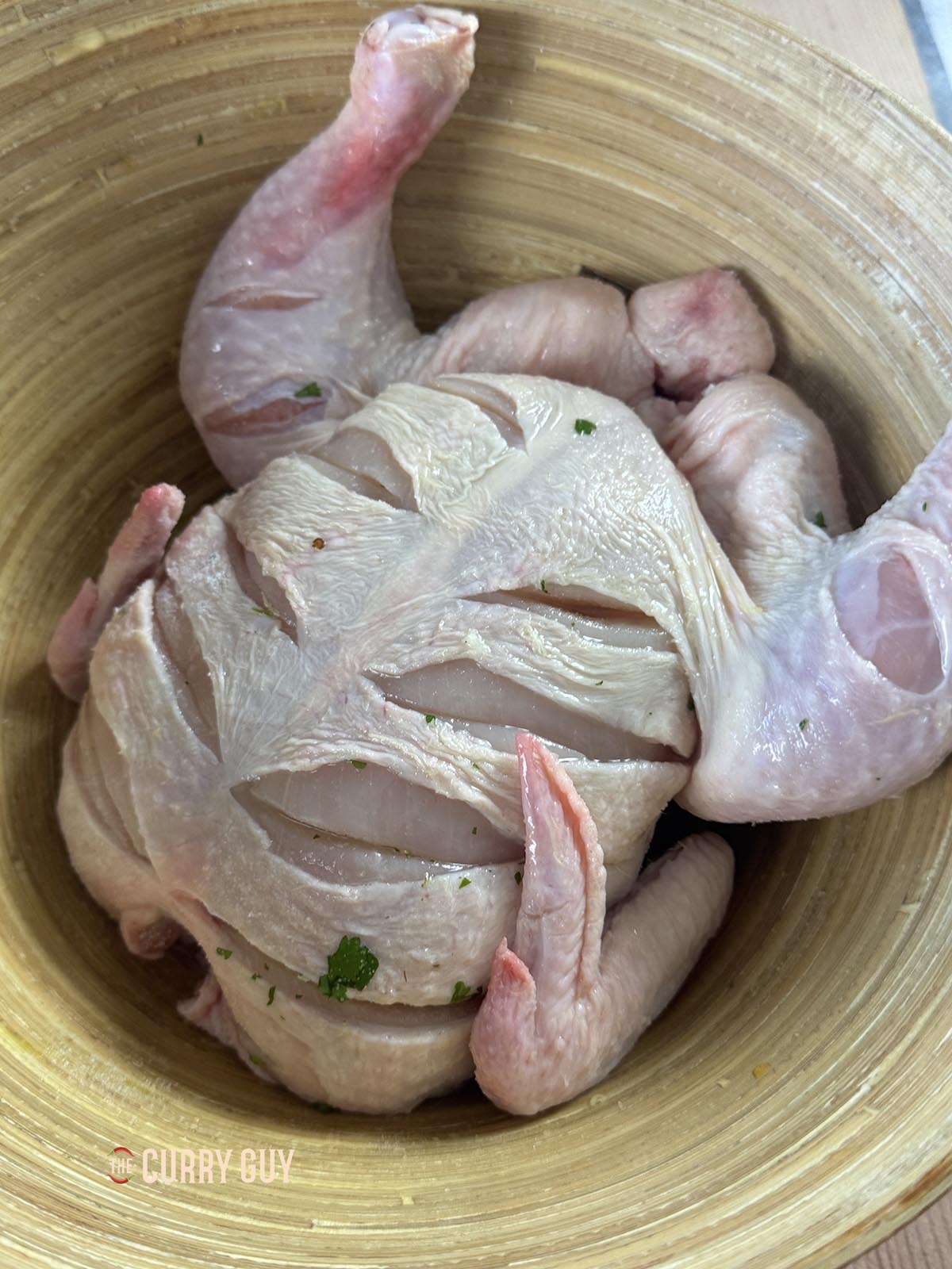 The chicken scored all over, ready for the marinade