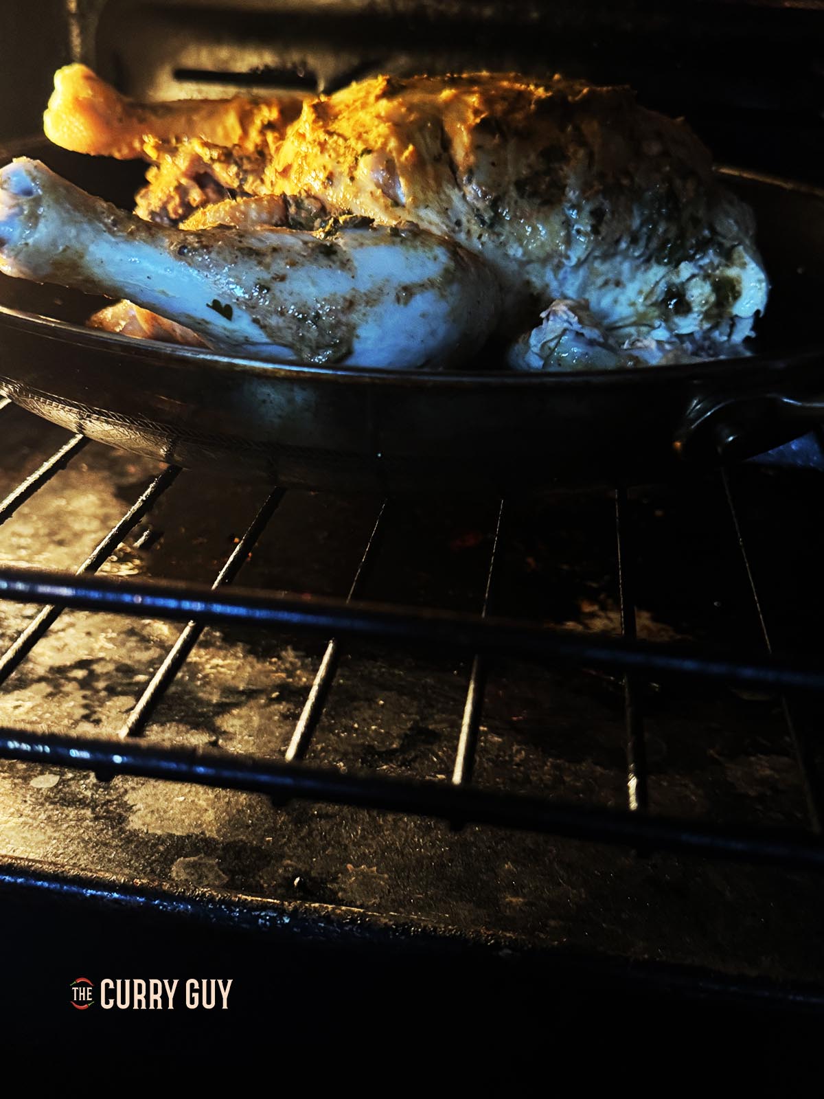 Grilling the chicken to char the skin in the oven.
