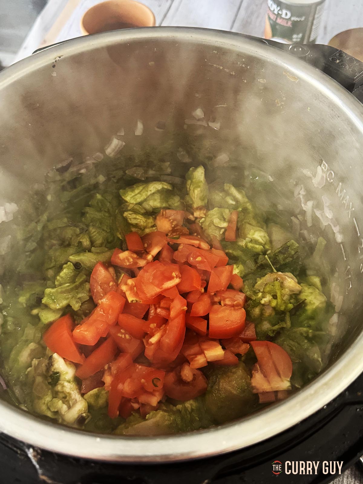 Adding the diced tomatoes to the pan.