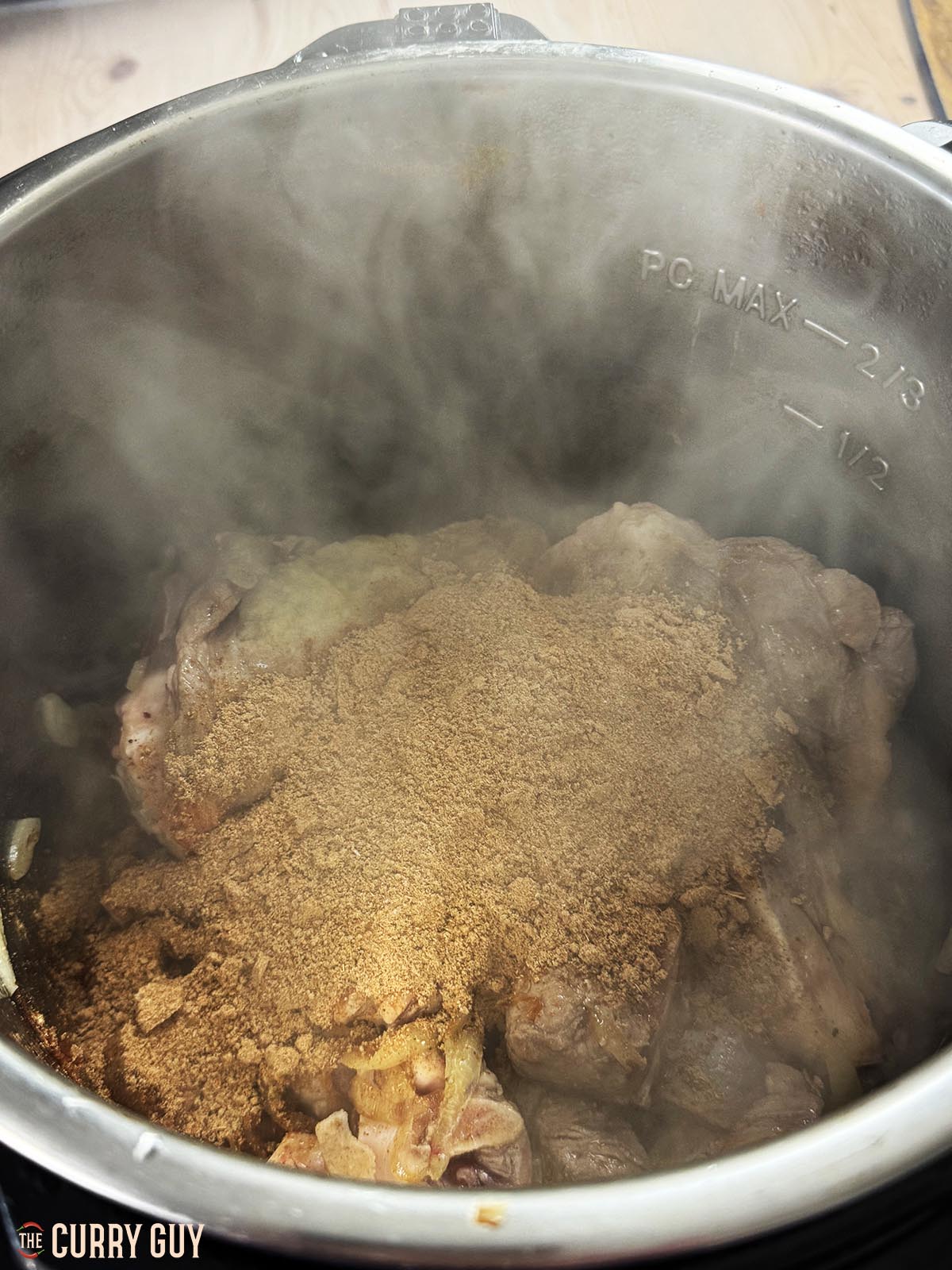 Adding the ground spice and flour mixture to the meat in the pot.