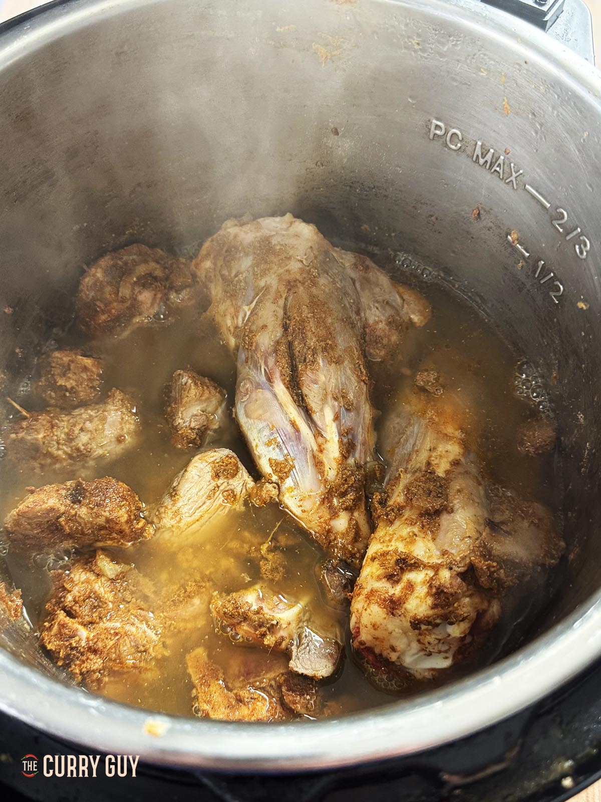 Adding water to the meat in the pot.