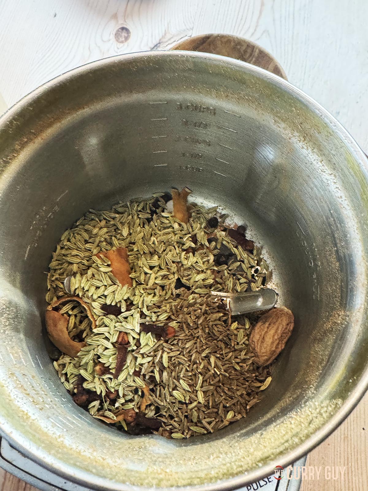 The whole spices in a spice grinder ready for grinding.