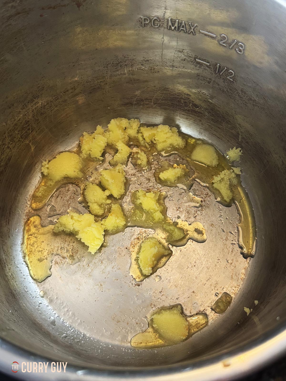 Melting the ghee in the slow cooker pot. 