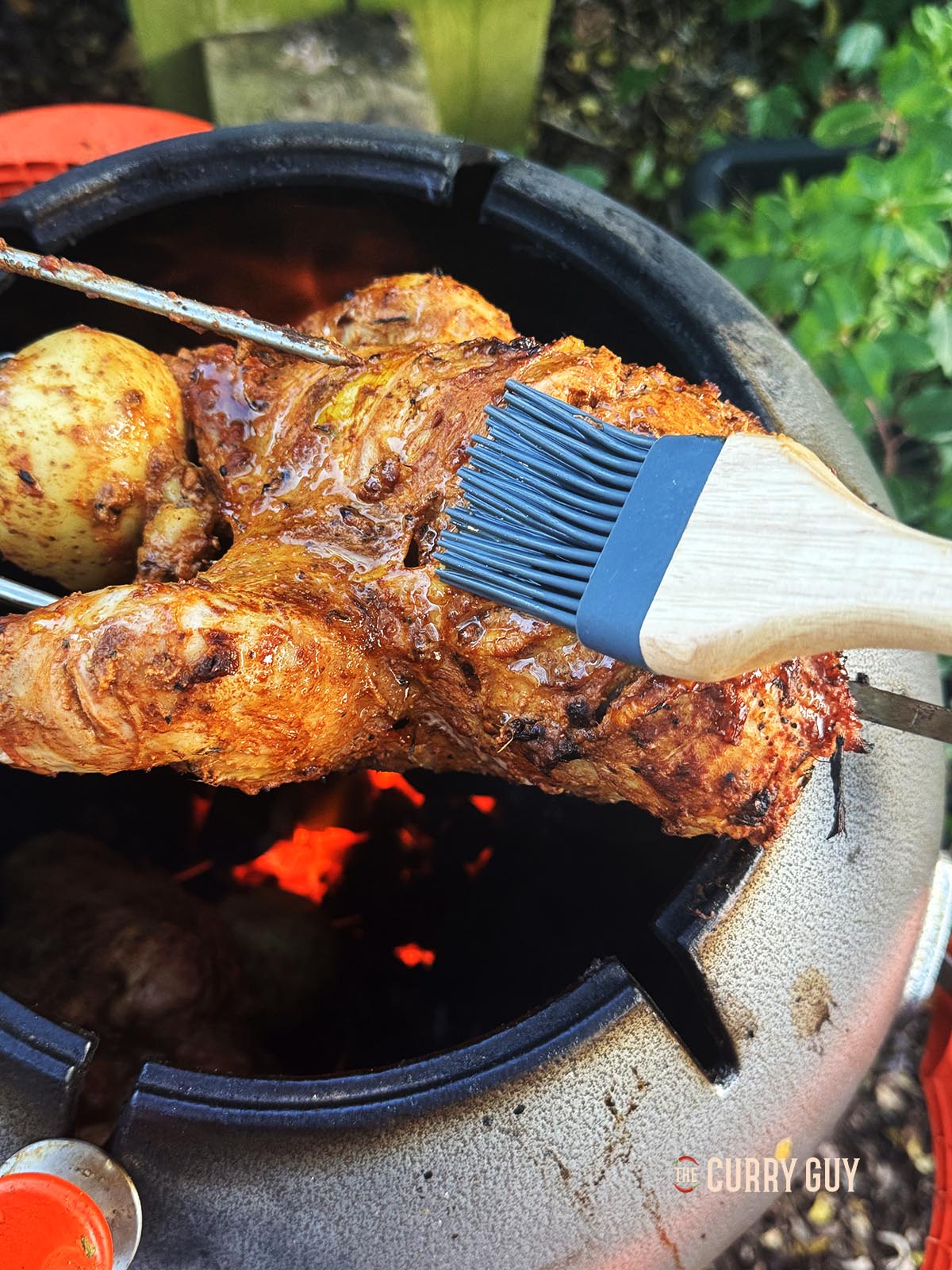 Basting the pheasant with melted ghee. 