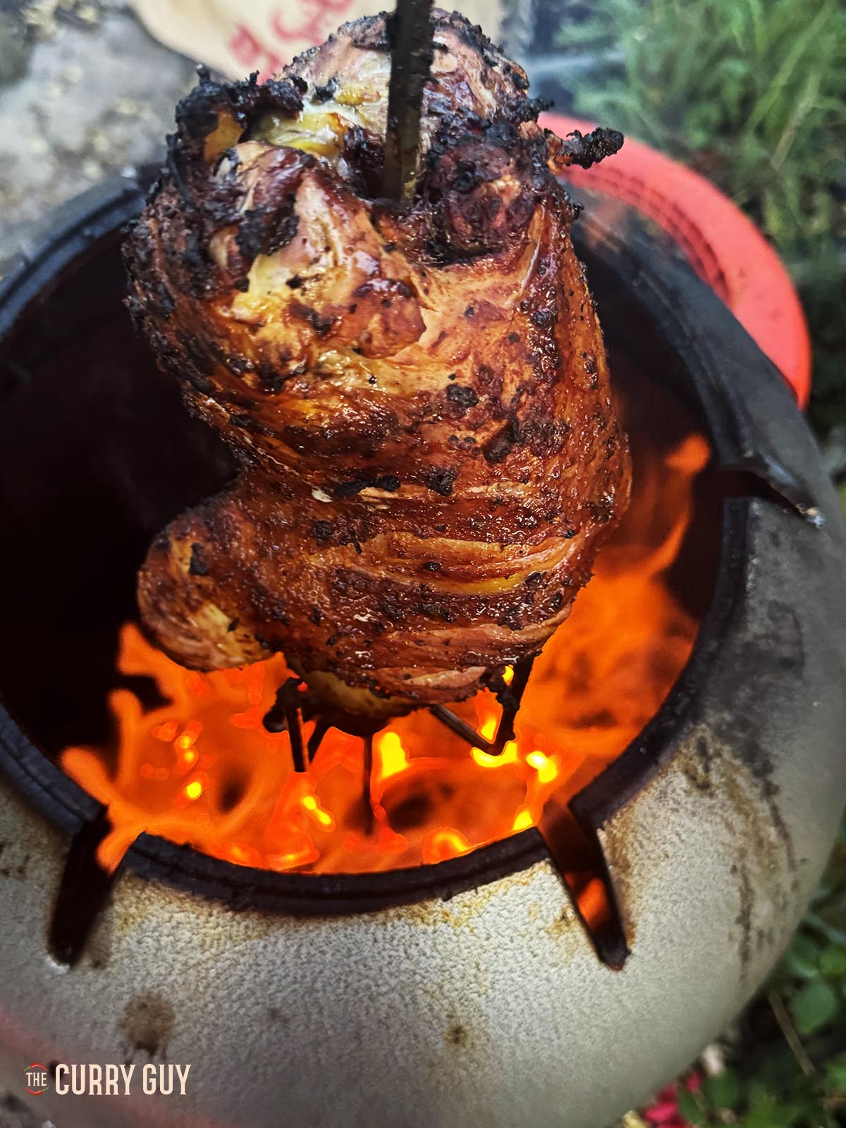 Finishing cooking the tandoori roast pheasant in the tandoor oven. 