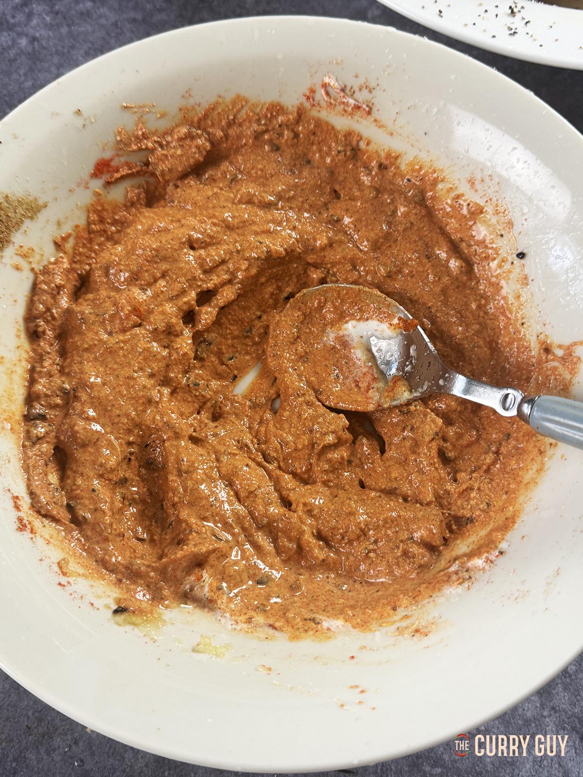 Stirring the marinade to combine the ingredients and make it smooth. 