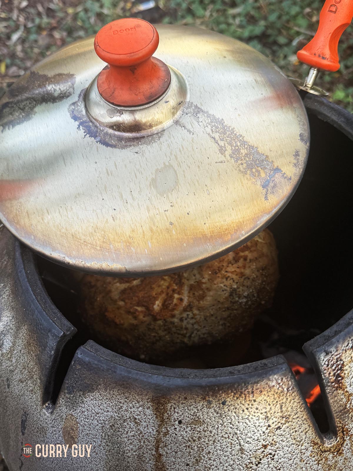 The turkey crown cooking with the lid half on to lower the heat.