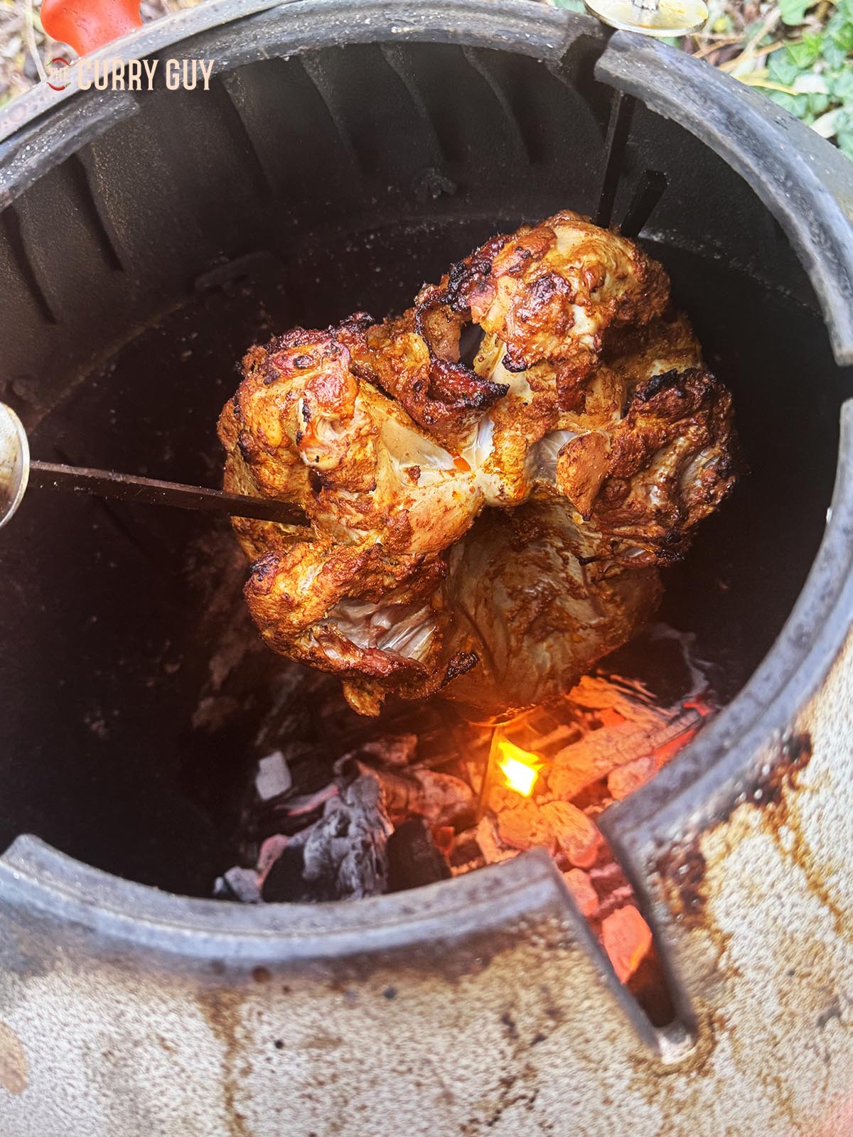 Turning the skin of the crown toward the wall, away from the burning charcoal.