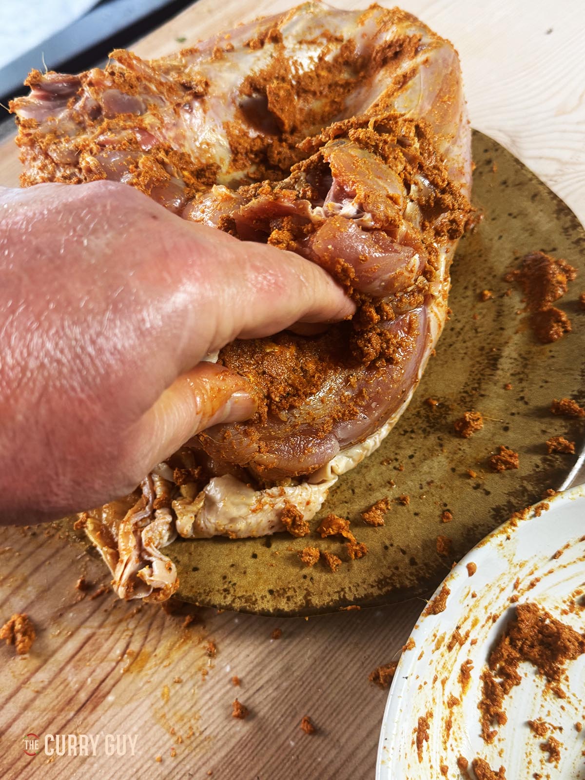 Rubbing the marinade into the flesh of the turkey.