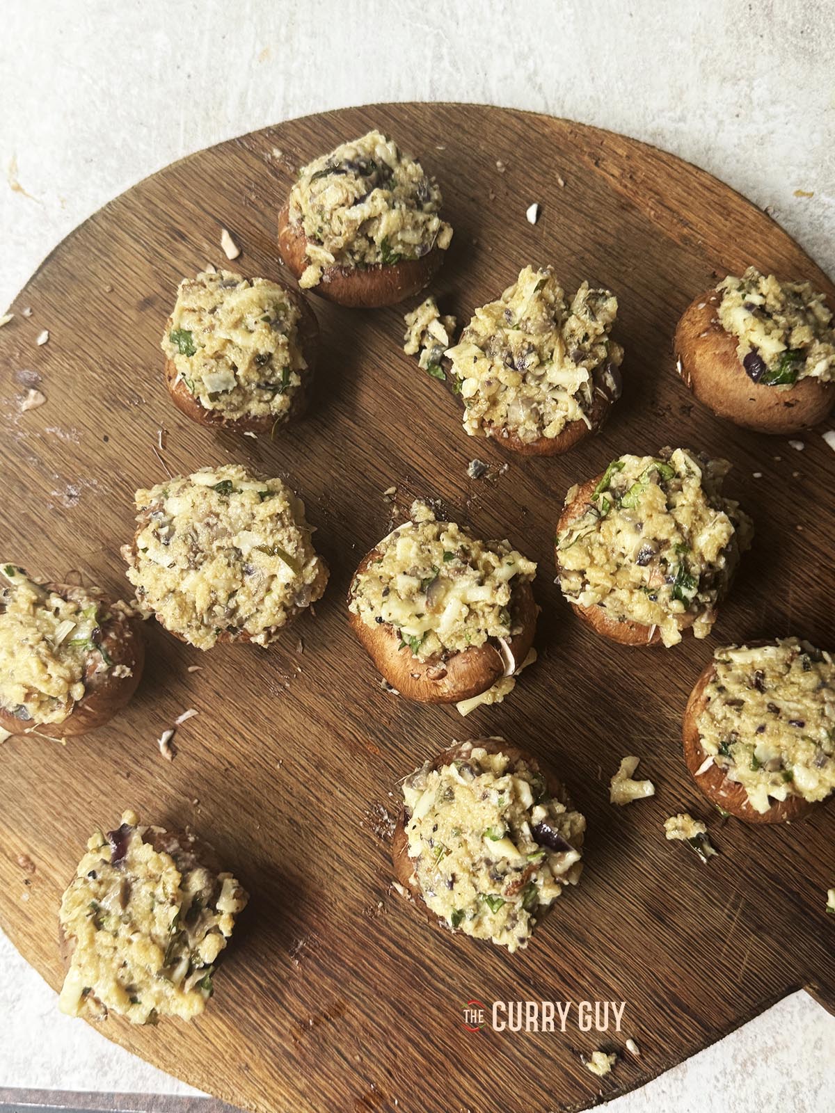 Filling the mushrooms with the stuffing.