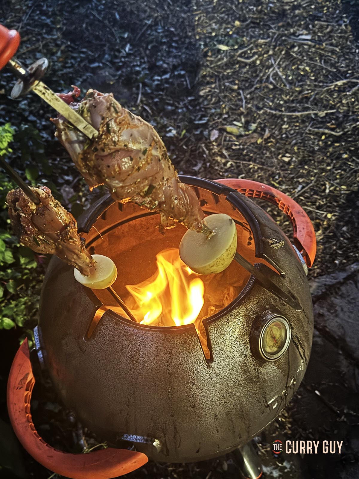 Placing the leg skewers in the tandoori oven.