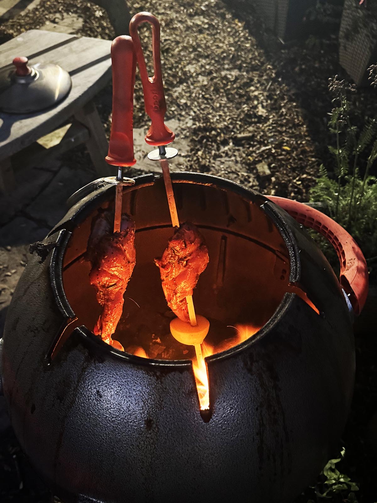 The leg meat cooking in the tandoor oven.