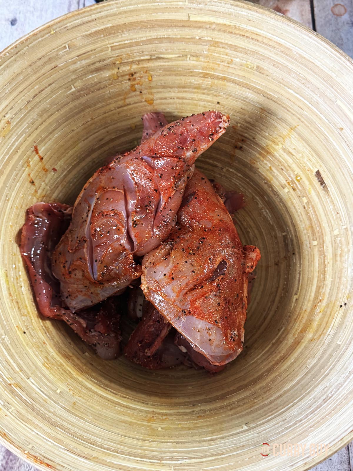 The rabbit pieces rubbed with salt, pepper, paprika and one tablespoon olive oil. 