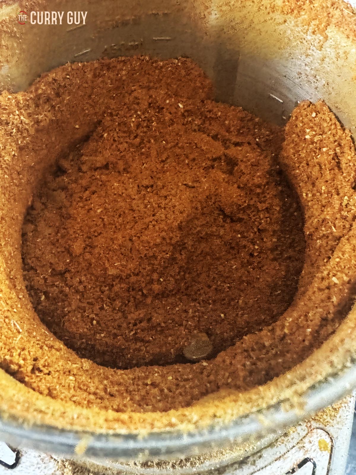 Blending in the remaining ground ingredients to make a curry powder. 