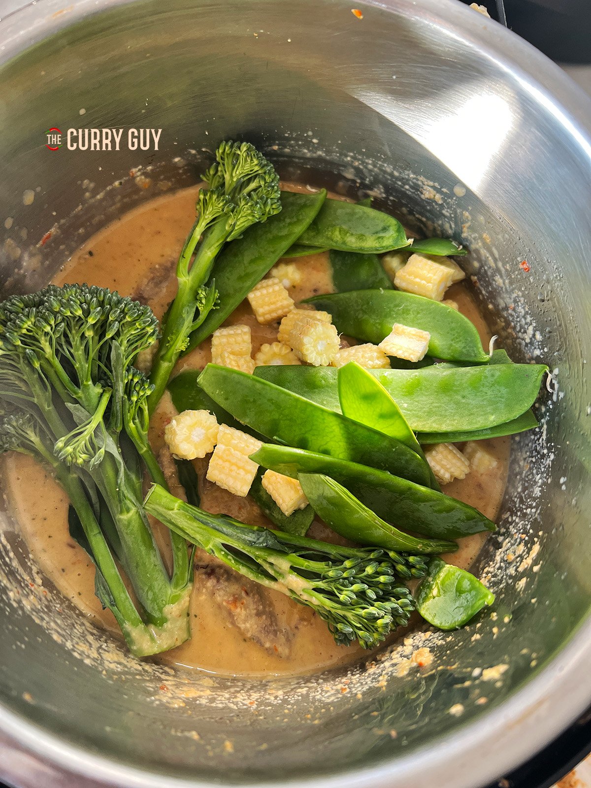 Adding vegetables for the slow cooker panang curry. 