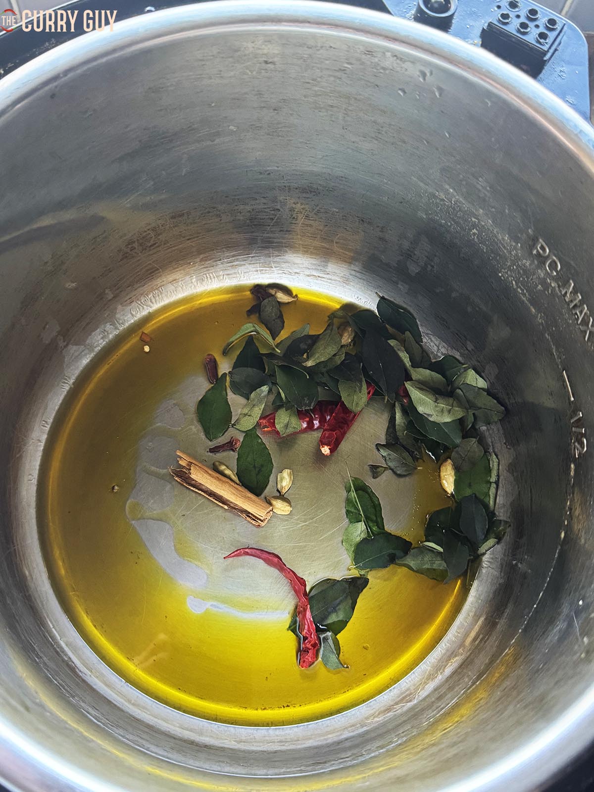 Infusing the whole spices and curry leaves in the oil.