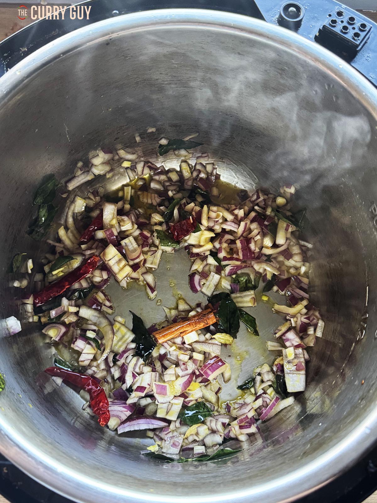 Stirring in the chopped onion to fry and soften.