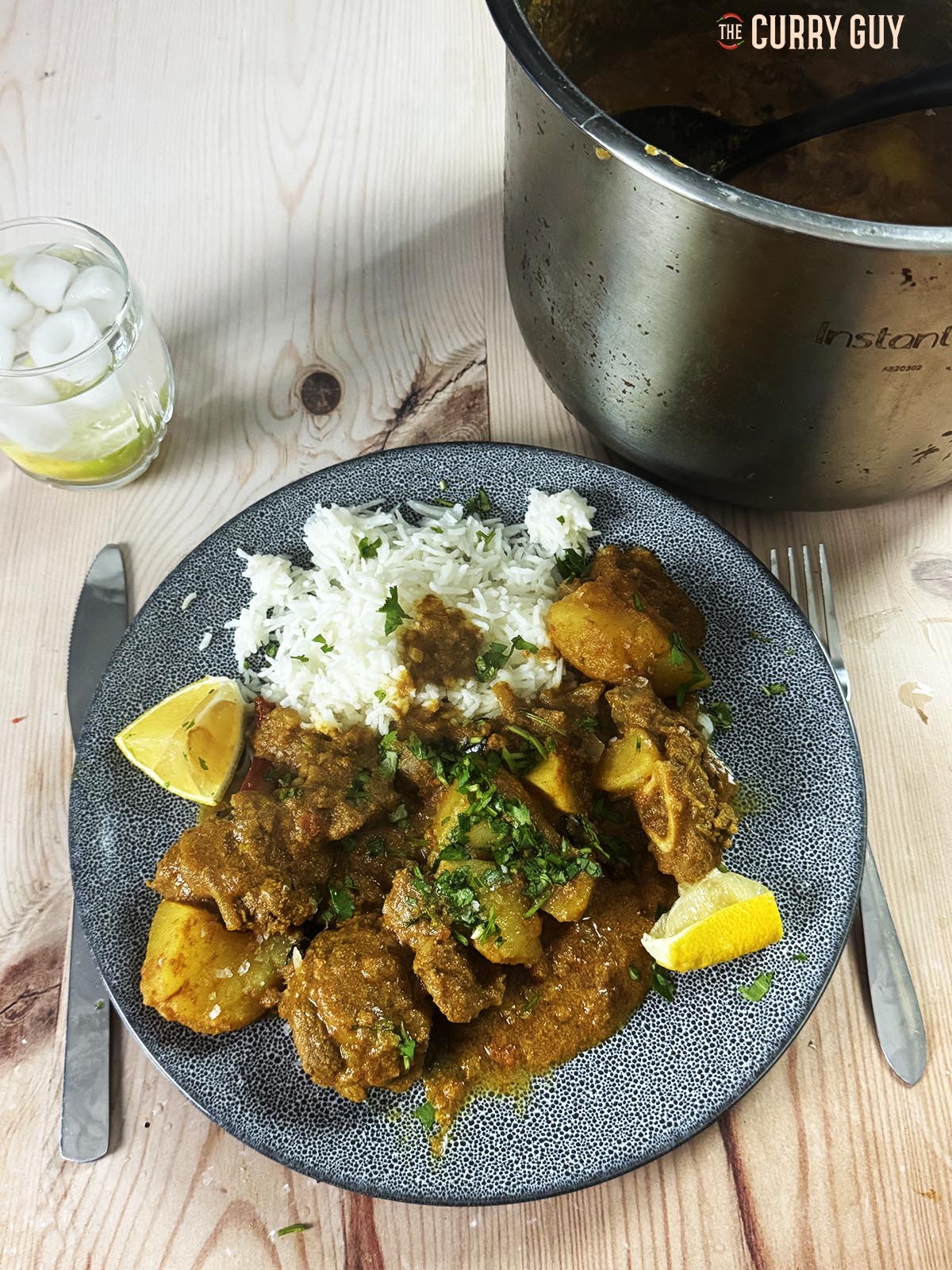 The railway lamb curry served on a plate at the table garnished with coriander. 