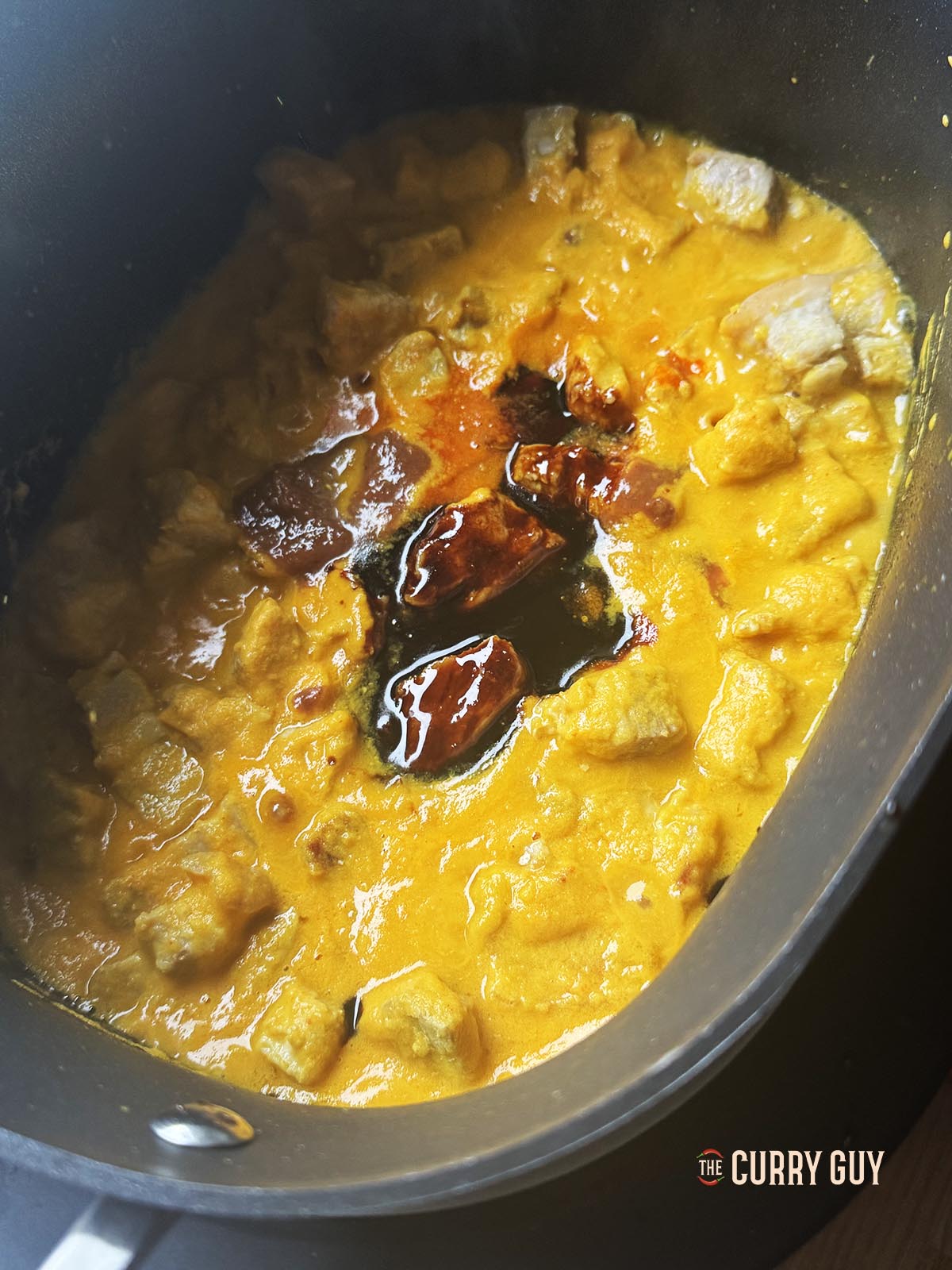 Adding the hot sauce, sugar, kecap manis and tamarind concentrate to the slow cooker.