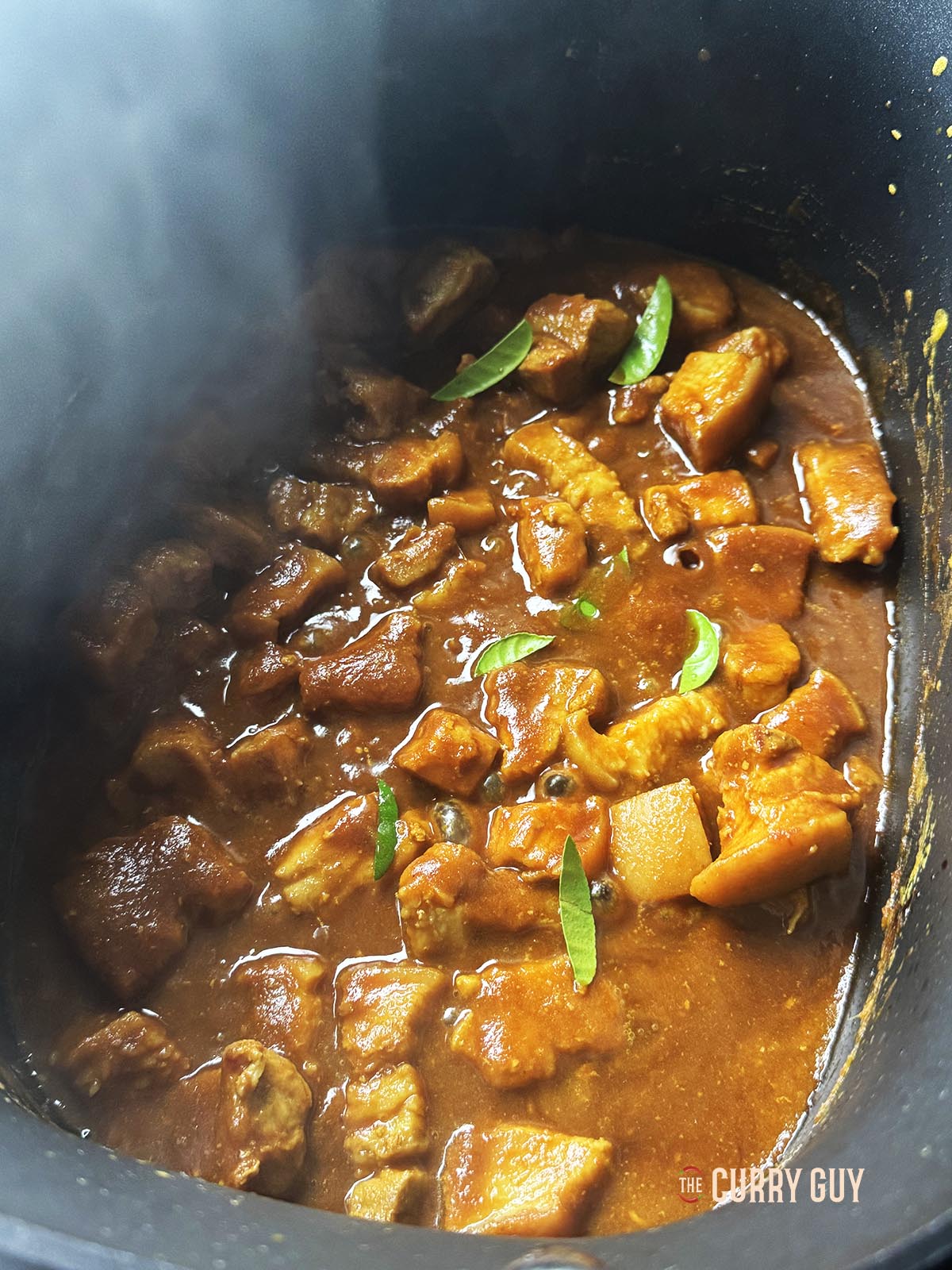 Adding the lime leaves and stirring it all up to combine.