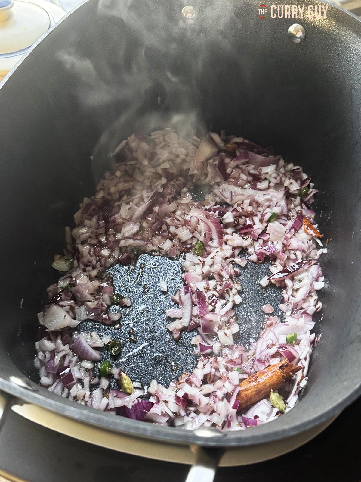 Frying the chopped onions, chillies and garlic and ginger 