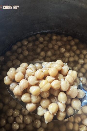 A spoonful of chickpeas cooked to perfection in a slow cooker.