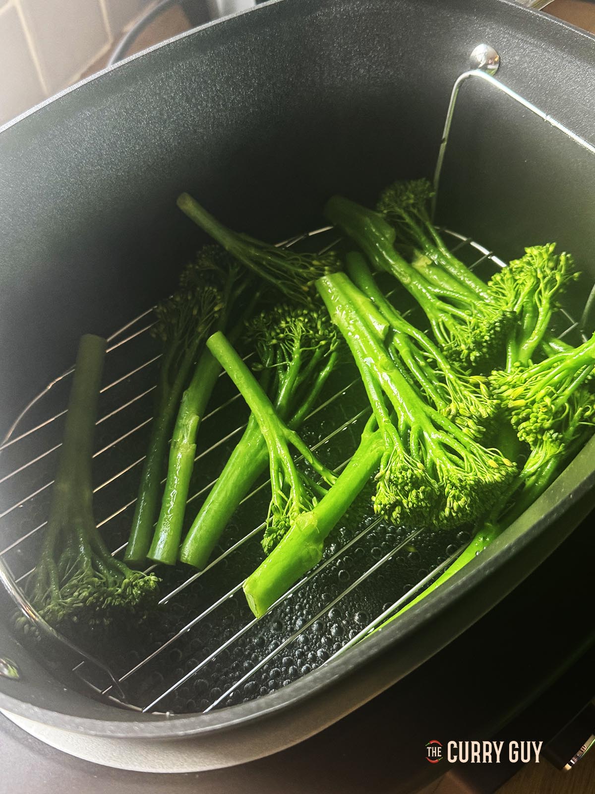 Steaming broccoli in a steamer for the curry.