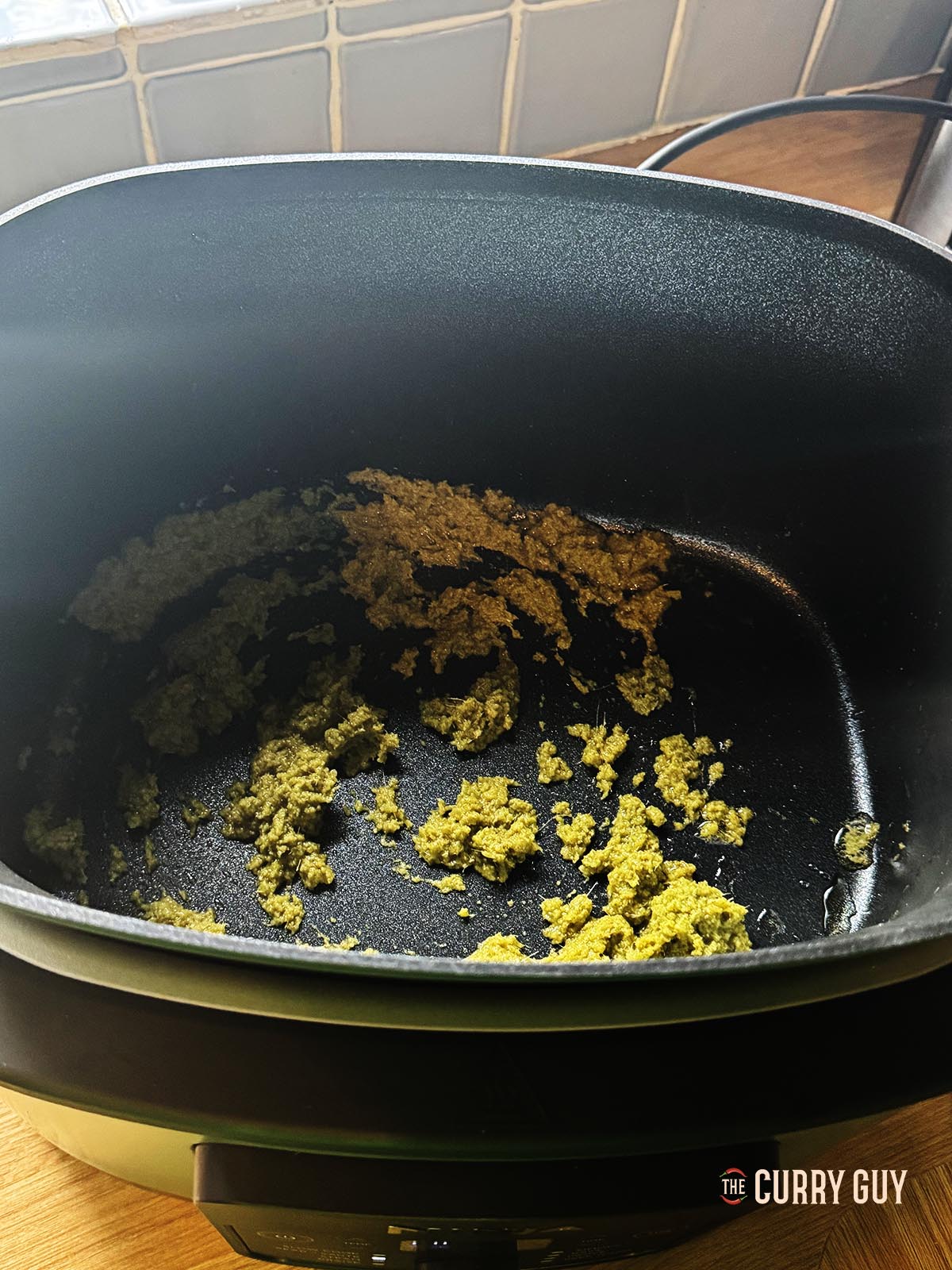 Frying the curry paste for a minute to cook out the rawness.