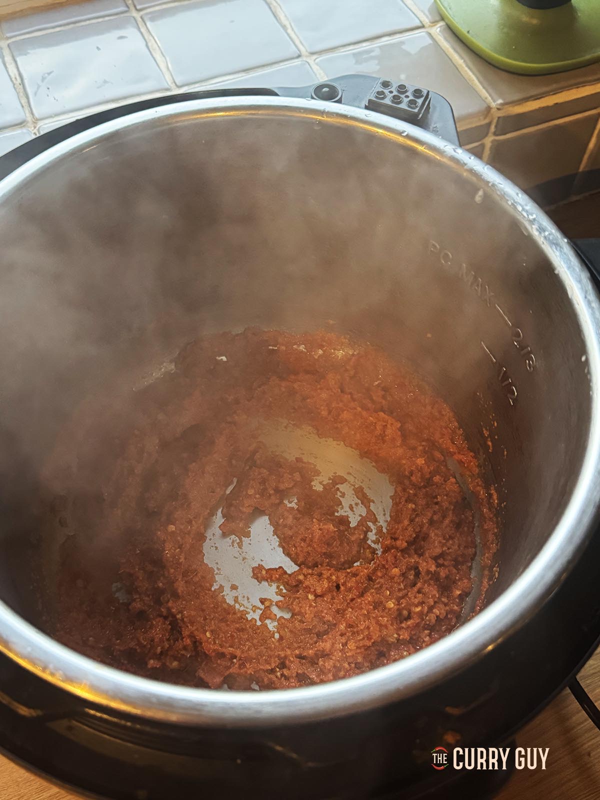 Frying the curry paste in a slow cooker set to searing mode. 