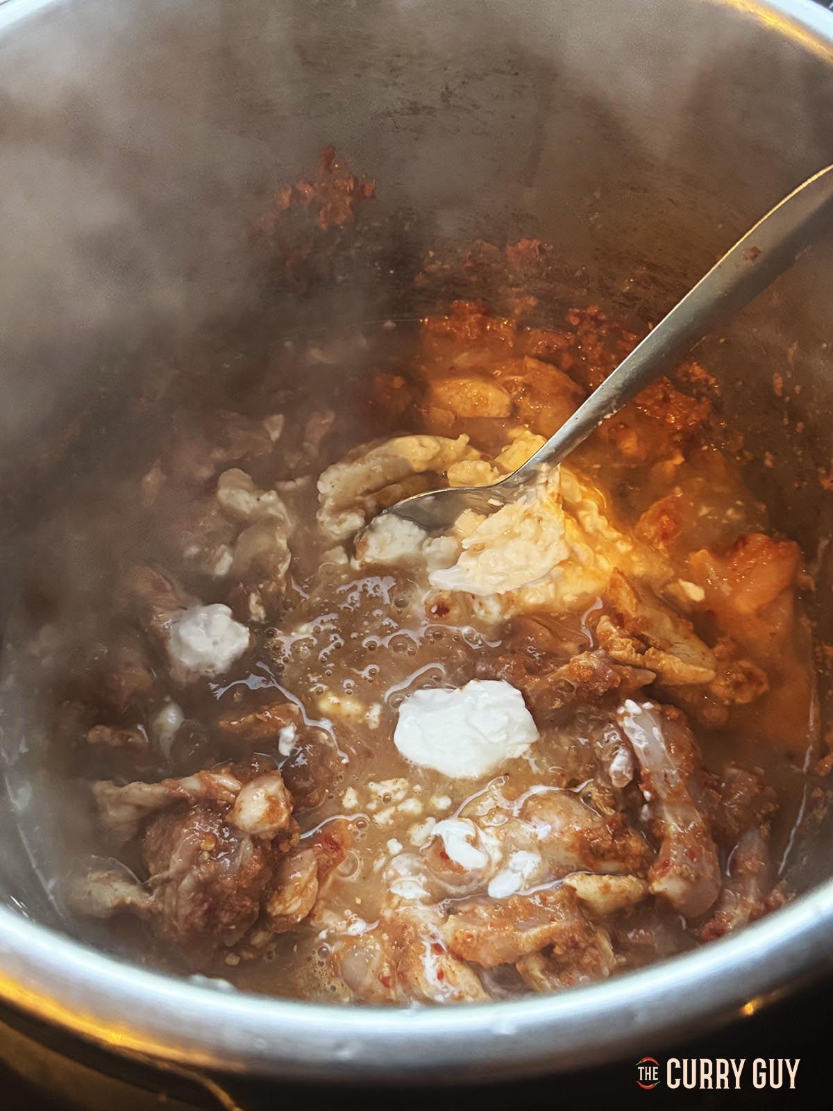 Stirring in the coconut milk, soy sauces and tamarind concentrate