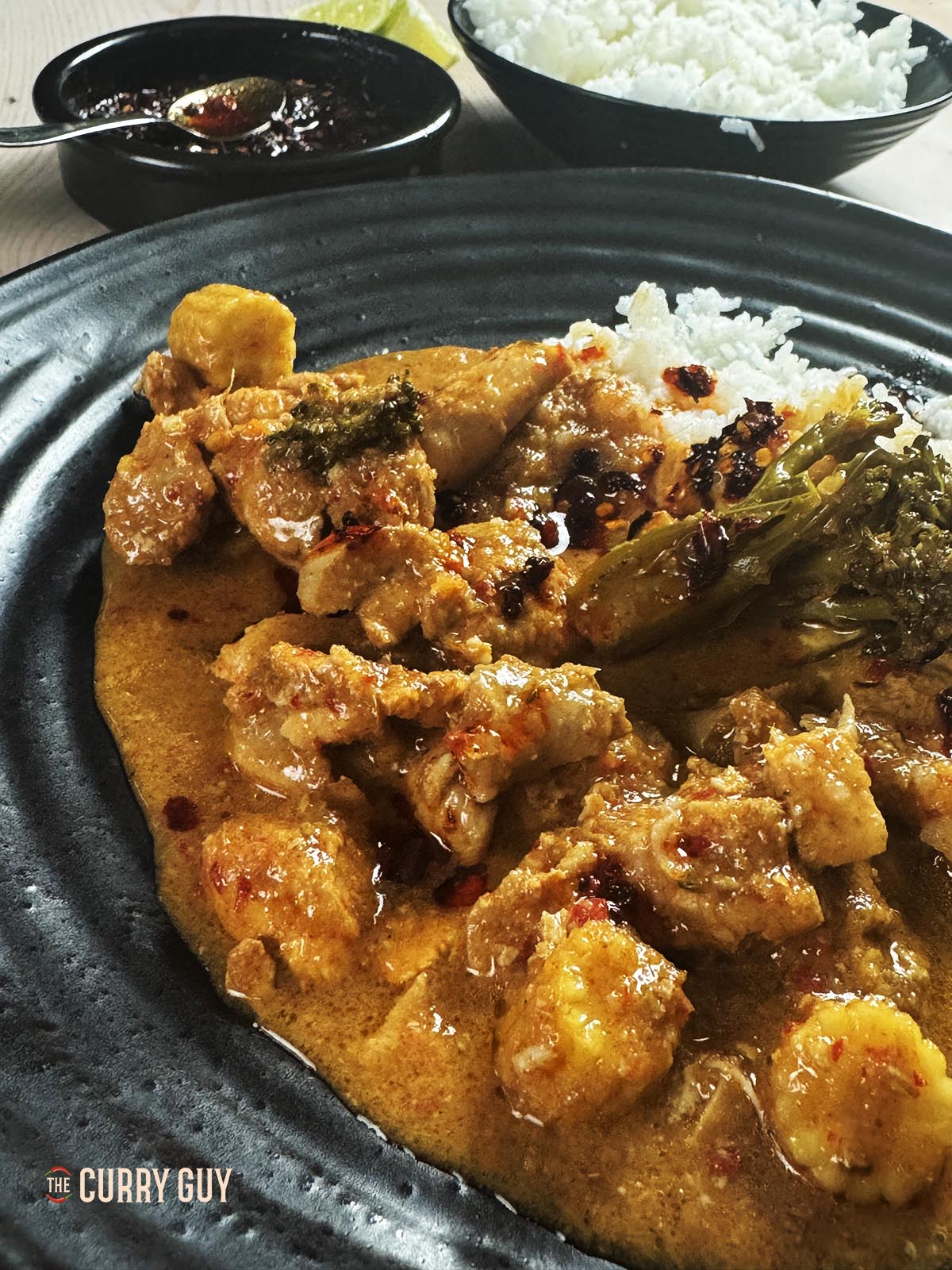 Slow cooker red Thai curry on a serving plate with rice. 