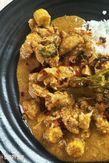 Slow cooker red Thai curry on a serving plate with rice.