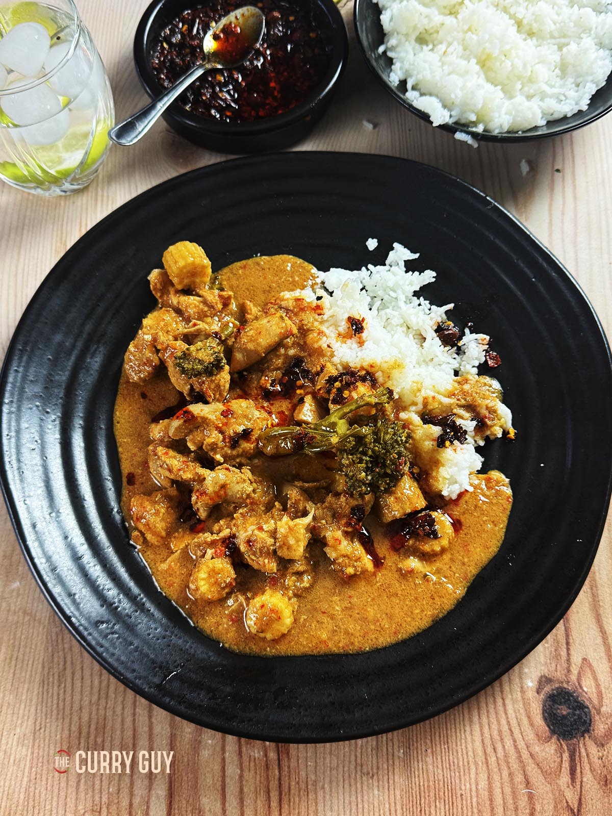 Slow cooker red Thai curry on a serving plate with rice. 