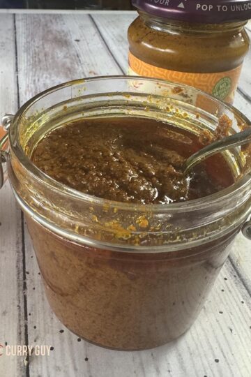 Tikka masala paste in a class jar ready to use next to a well known brand of tikka masala paste.