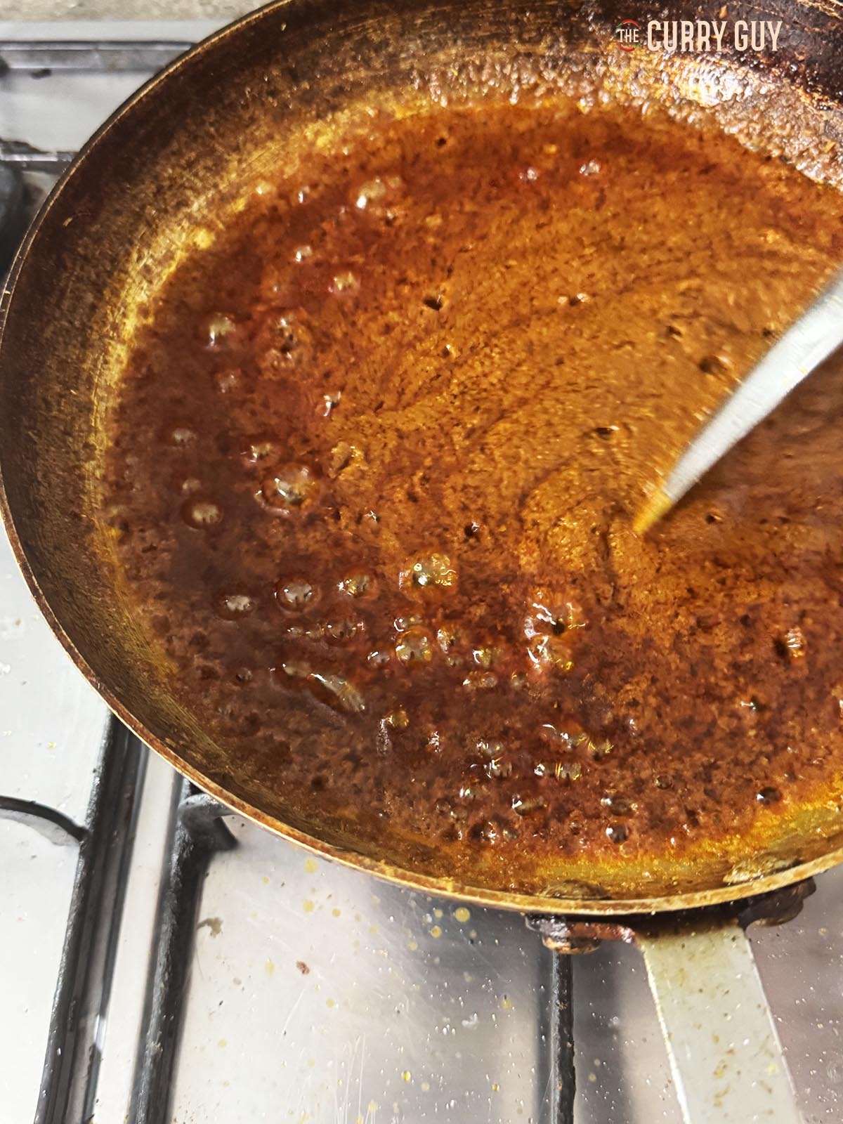 Simmering the paste and adding vinegar.