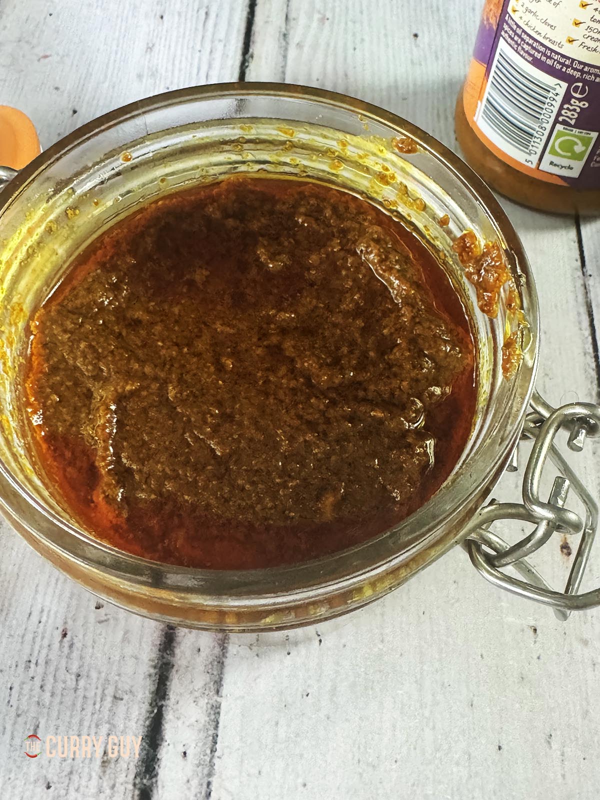 The spice paste in a jar, topped with some of the oil. 