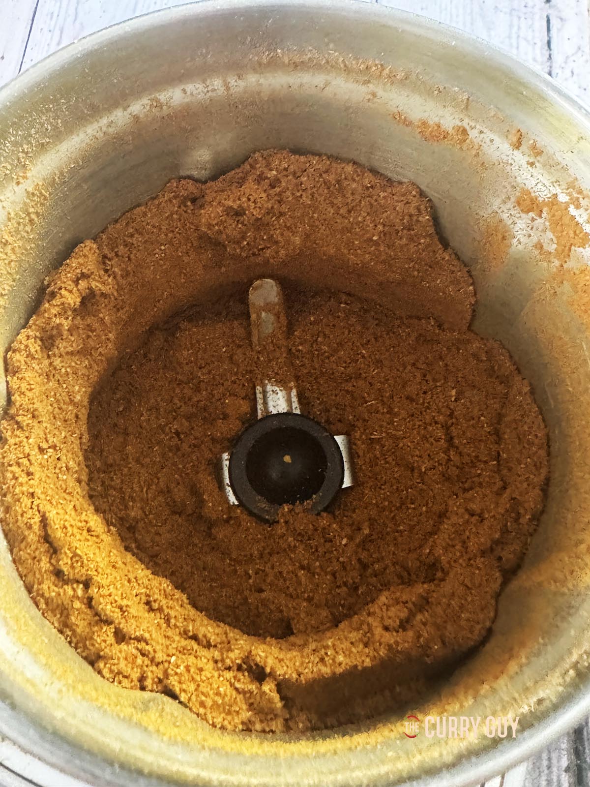 Blending the ground ingredients into the powder.