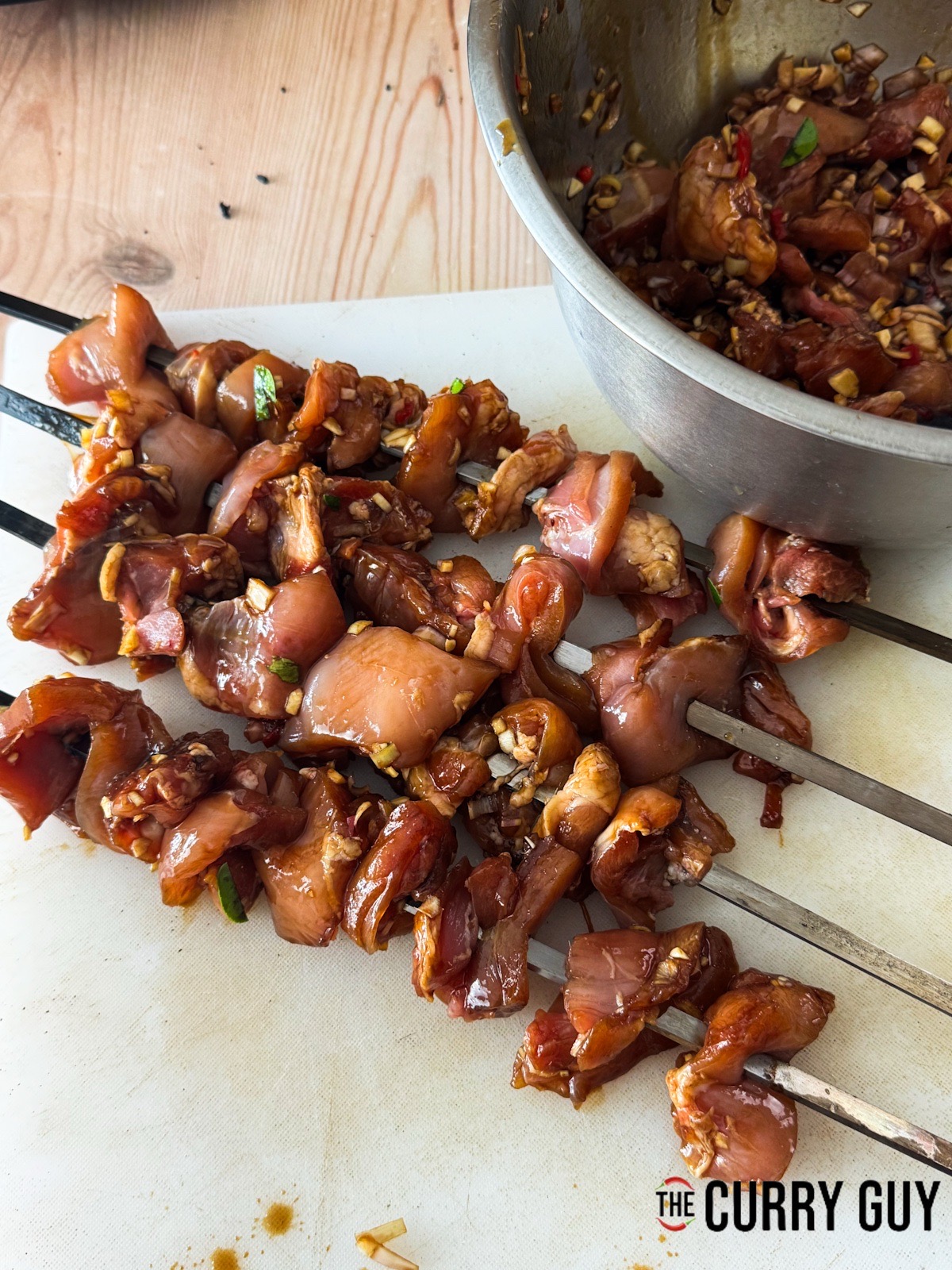 The marinated chicken skewered and ready to cook.