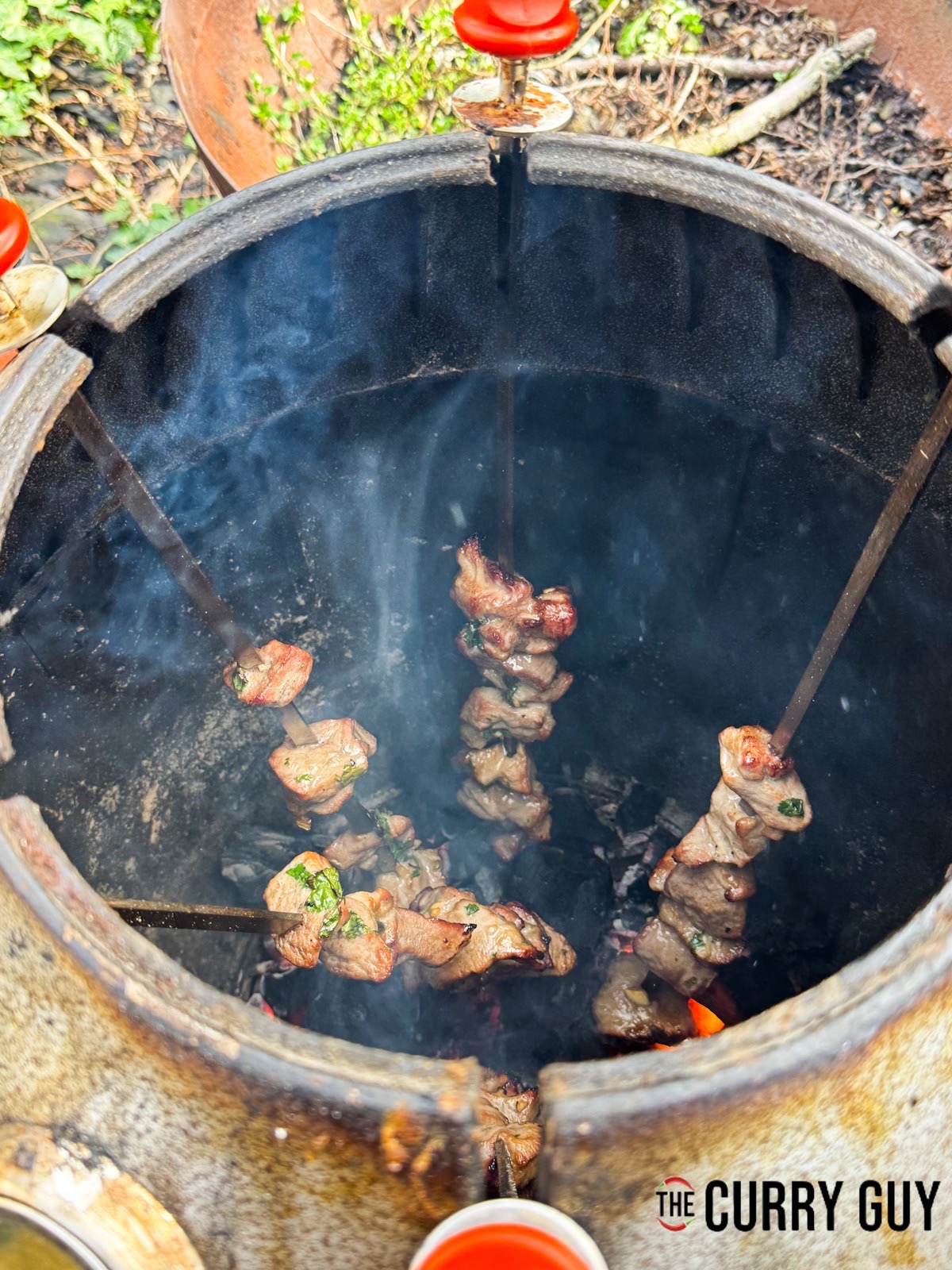 Cooked Thai pork skewers in a tandoor oven.