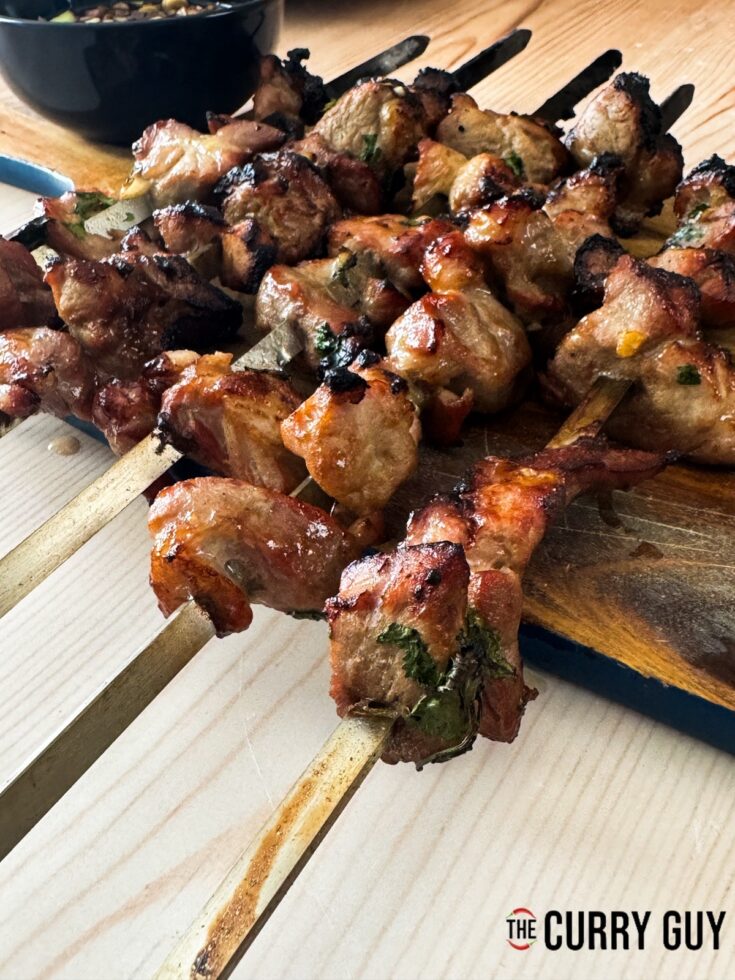 Thai pork skewers on a serving platter.