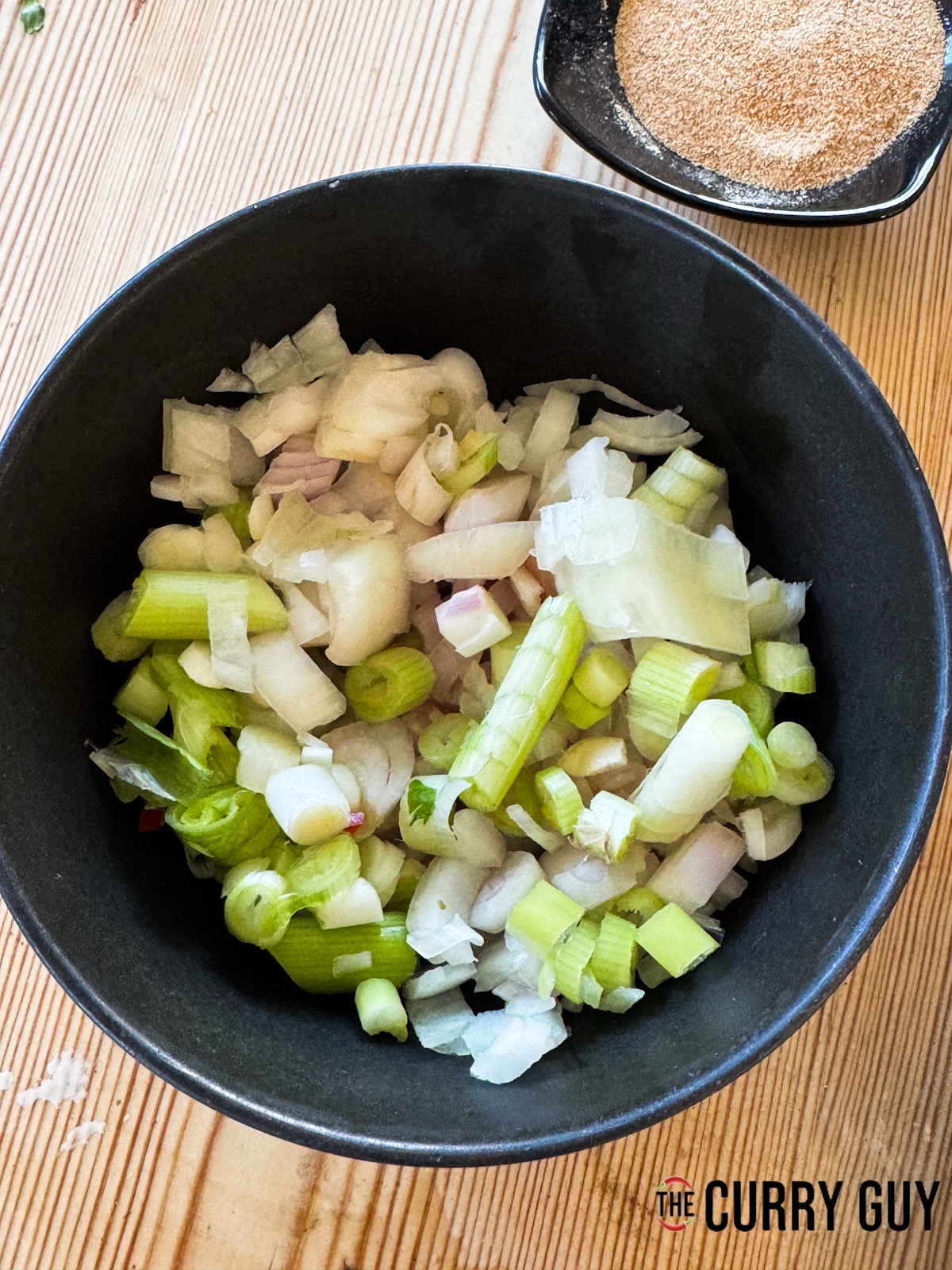 The chopped aromatics for the sauce in a bowl.