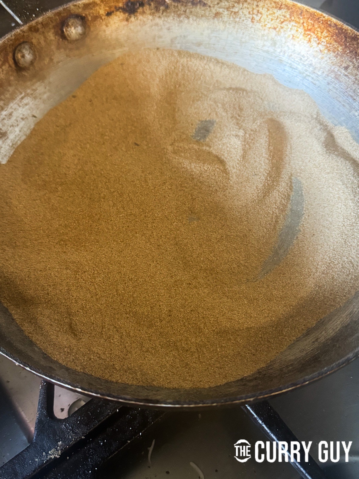 Toasted rice flour in a pan.
