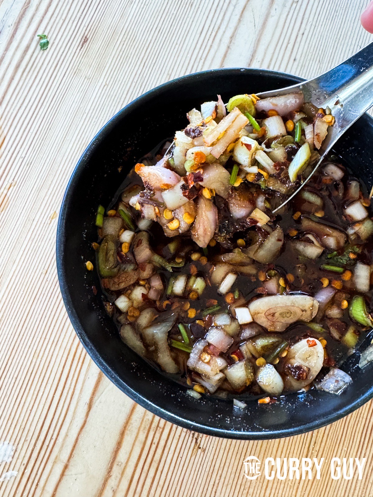 Stirring the nam jim jaew sauce together to combine.