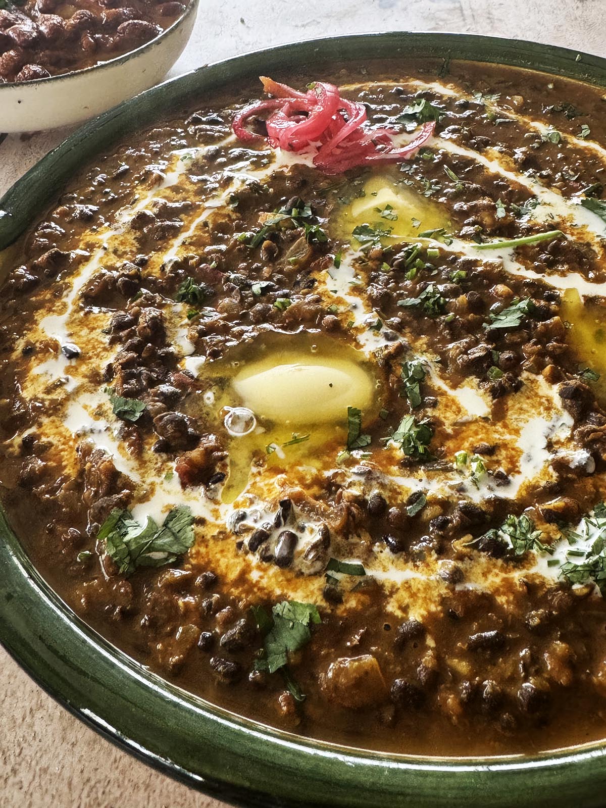 The finished dal makhani garnished with butter and cream.