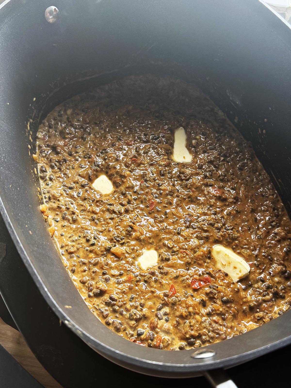 Adding butter to the dal.