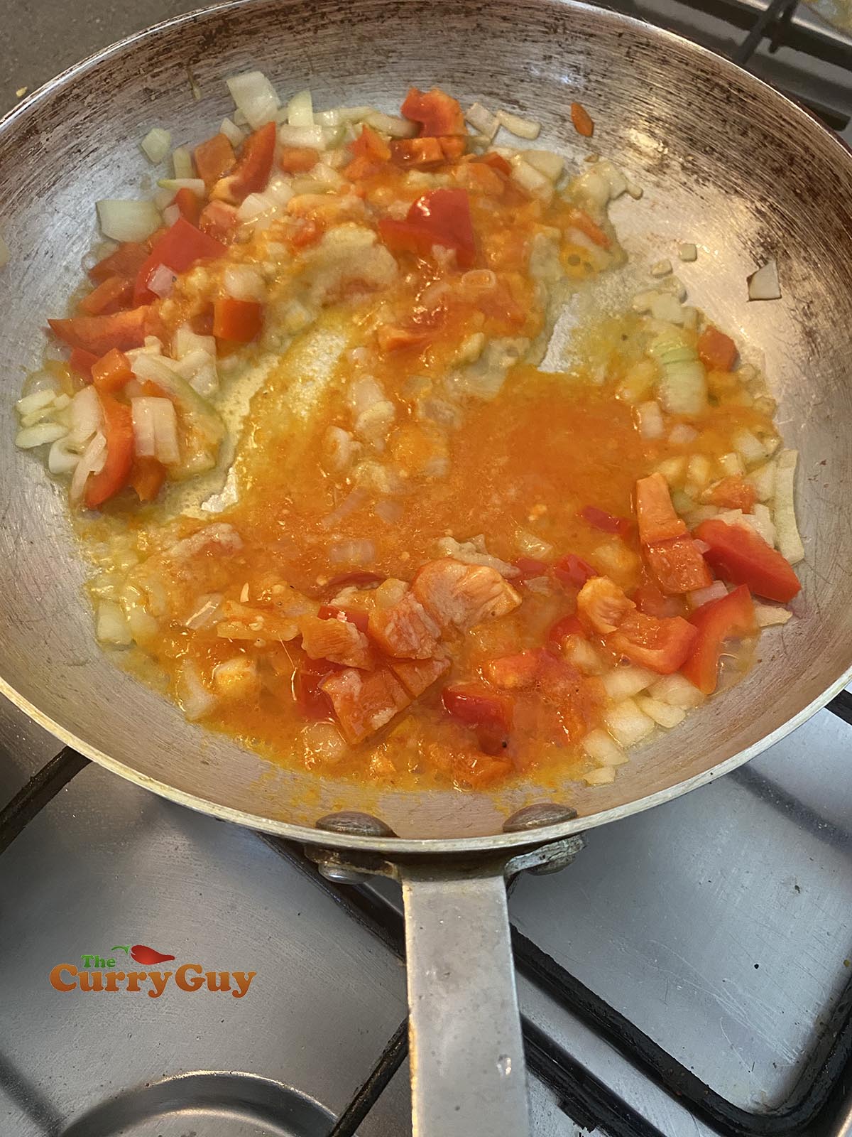 adding base sauce to the curry