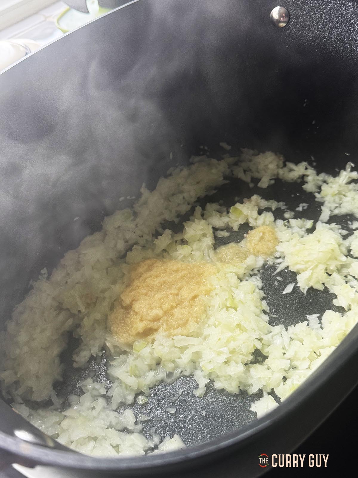 Adding garlic and ginger paste to the pan.