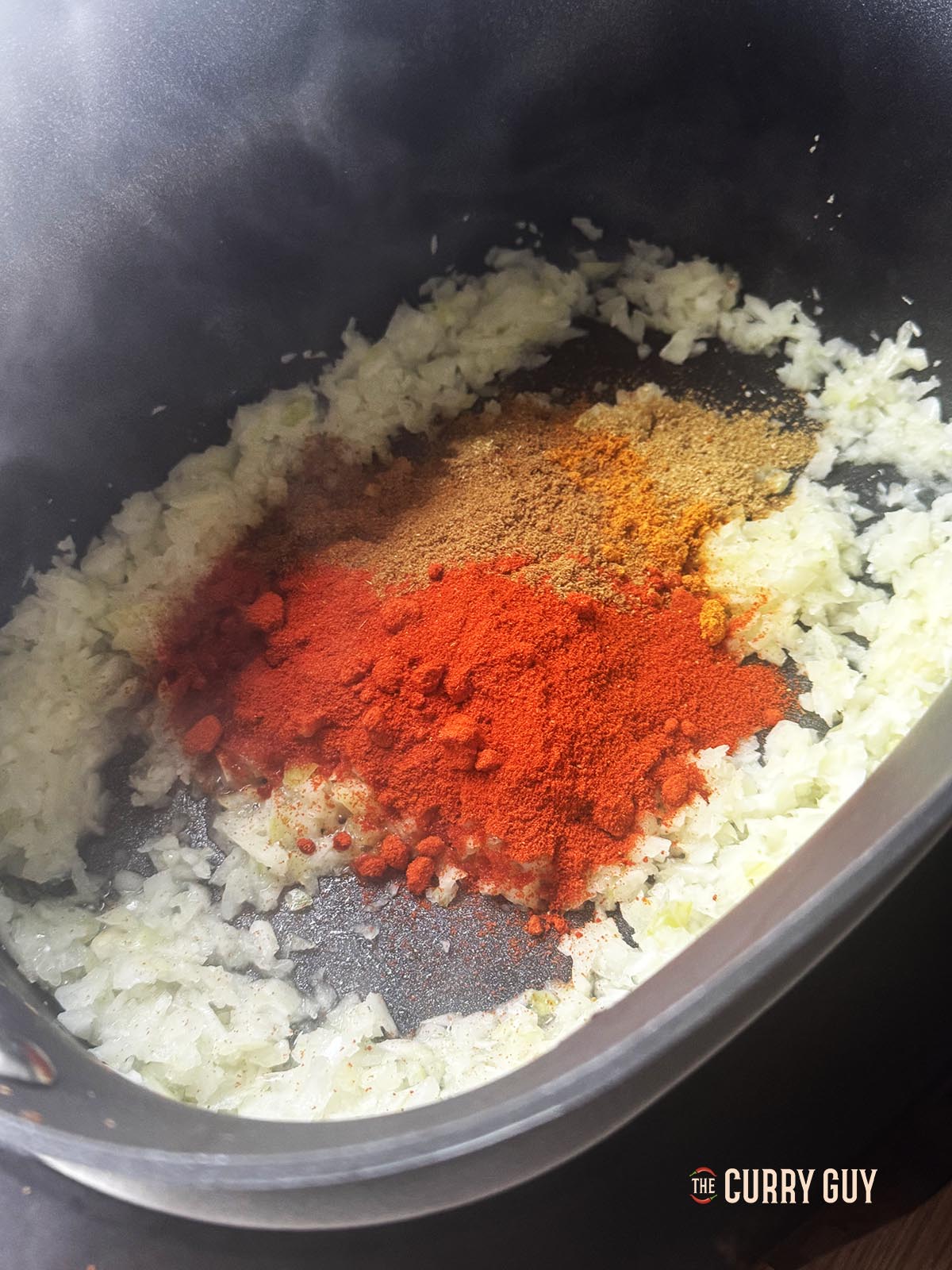 Adding the spices to the fried onions, garlic and ginger.