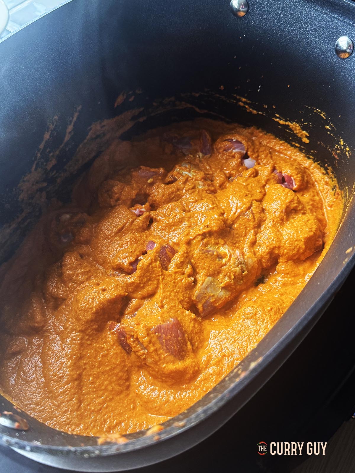 Stirring the meat into the sauce to cook.