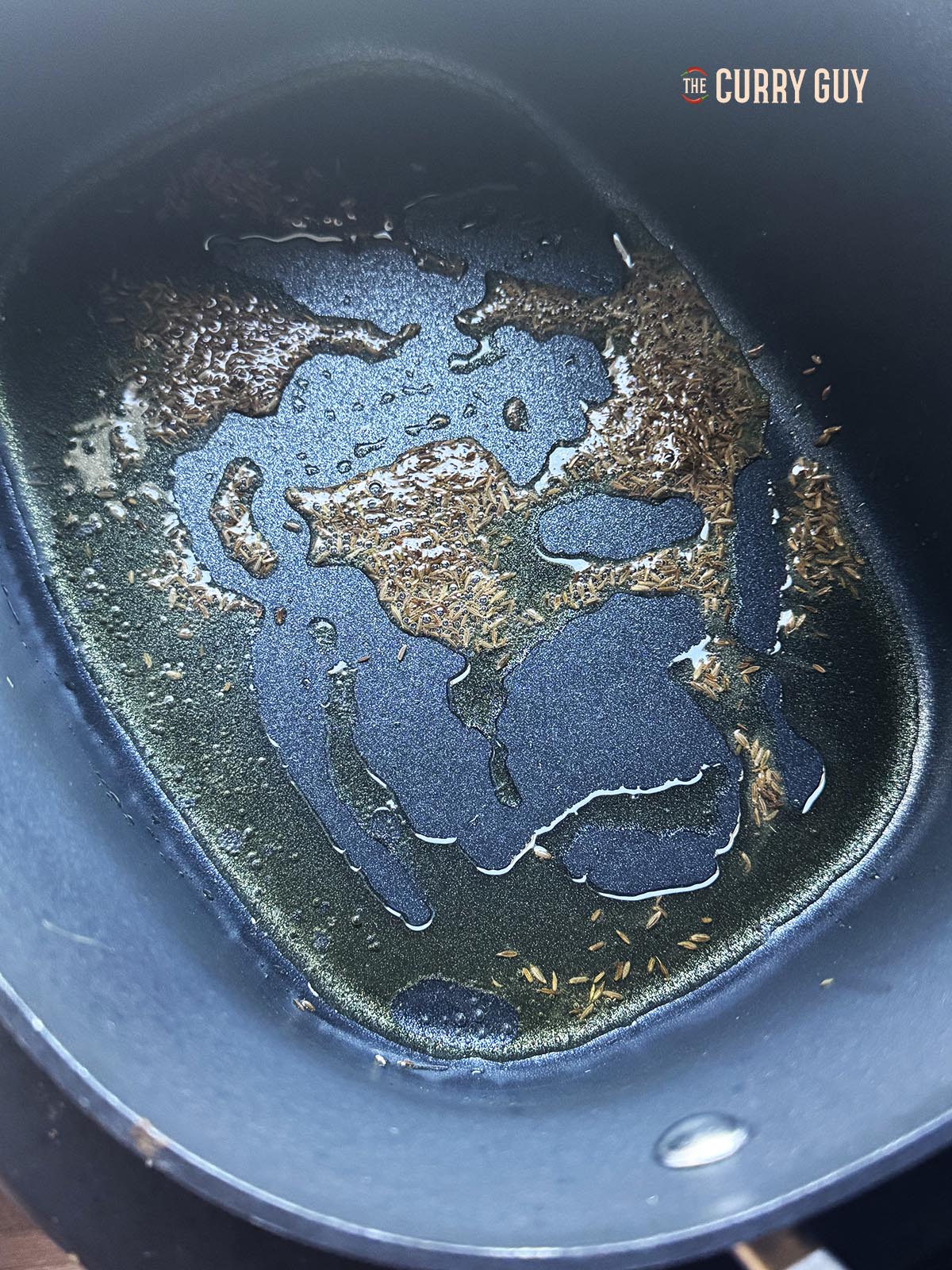 Infusing cumin seeds in a slow cooker in oil using the sauté function.
